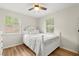 Serene bedroom featuring a comfortable bed, hardwood floors, and plenty of natural light at 2311 Vincent Rd, Orlando, FL 32817