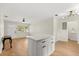 Open-concept layout with kitchen island that connects to the living area and laundry room at 2311 Vincent Rd, Orlando, FL 32817