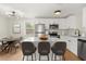 Modern eat-in kitchen featuring white cabinets, stainless steel appliances, and a large island at 2311 Vincent Rd, Orlando, FL 32817