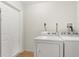 Bright laundry room featuring a side-by-side washer and dryer at 2311 Vincent Rd, Orlando, FL 32817