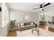 Bright living room with stylish furnishings, ceiling fan, and seamless open-concept design at 2311 Vincent Rd, Orlando, FL 32817