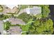Aerial view highlighting mature landscaping and backyard area near waterfront at 2512 Baywater Rd, Tavares, FL 32778