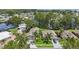 Aerial view showcasing a residential area with well-kept lawns, lush trees, and proximity to a waterway at 2512 Baywater Rd, Tavares, FL 32778