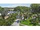 Aerial view of a home with lush landscaping and a long driveway leading to a lake, showcasing waterfront living at 2512 Baywater Rd, Tavares, FL 32778