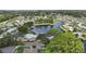 Aerial view capturing a serene lakeside community with a mix of residential homes and lush natural landscapes at 2512 Baywater Rd, Tavares, FL 32778