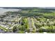 Aerial view of waterfront homes with canal access, lush landscaping, and views of a lake and surrounding woodlands at 2512 Baywater Rd, Tavares, FL 32778