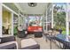 Enjoy the outdoors in this comfortable screened-in porch with great backyard views at 2512 Baywater Rd, Tavares, FL 32778