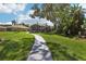 Picturesque backyard with a winding pathway, mature trees, and a serene setting at 2512 Baywater Rd, Tavares, FL 32778