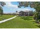 Expansive backyard featuring a walkway, lush green lawn, and mature trees for privacy at 2512 Baywater Rd, Tavares, FL 32778
