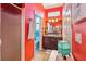 Vibrant bathroom with shower, vanity, and mirror, featuring bright red walls at 2512 Baywater Rd, Tavares, FL 32778