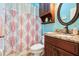 Charming bathroom with a patterned shower curtain and a dark wood vanity with granite countertops at 2512 Baywater Rd, Tavares, FL 32778