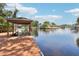 Waterfront property with a wooden dock and covered boathouse on a lush canal at 2512 Baywater Rd, Tavares, FL 32778