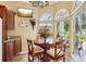 Bright breakfast nook with arched windows and views of the beautifully landscaped backyard at 2512 Baywater Rd, Tavares, FL 32778