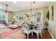 Cozy dining area adjacent to living room, featuring chandelier, plantation shutters, and stylish decor at 2512 Baywater Rd, Tavares, FL 32778