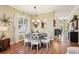 Elegant dining space with chandelier, hardwood floors, and open view into the adjoining kitchen at 2512 Baywater Rd, Tavares, FL 32778