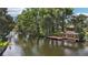 Waterfront home with a private wooden dock and covered boathouse on a lush canal at 2512 Baywater Rd, Tavares, FL 32778