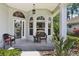 Inviting front porch with comfortable seating, elegant arched windows, and lush landscaping at 2512 Baywater Rd, Tavares, FL 32778