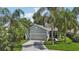 Charming home exterior with well-maintained landscaping, a concrete driveway, and a welcoming entrance at 2512 Baywater Rd, Tavares, FL 32778