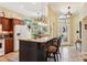 Bright kitchen with a granite island, barstool seating and stainless steel appliances at 2512 Baywater Rd, Tavares, FL 32778