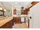 Bright and functional kitchen with granite counters, cabinetry, and tile floors at 2512 Baywater Rd, Tavares, FL 32778