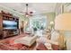 Spacious living room with hardwood flooring, elegant furniture, and open view to the sunroom at 2512 Baywater Rd, Tavares, FL 32778