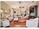 Open-concept living area with hardwood floors, ceiling fan, and seamless flow into the dining area at 2512 Baywater Rd, Tavares, FL 32778