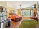Spacious bedroom with ceiling fan, hardwood floors, and large window, providing ample natural light at 2512 Baywater Rd, Tavares, FL 32778