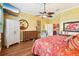 Bright, airy bedroom with a ceiling fan, hardwood floors, and neutral walls at 2512 Baywater Rd, Tavares, FL 32778