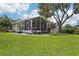 Relaxing sunroom overlooking the well manicured lawn at 2512 Baywater Rd, Tavares, FL 32778