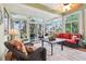 Inviting sunroom with lots of natural light, ceiling fan and comfortable seating at 2512 Baywater Rd, Tavares, FL 32778