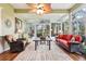 Bright sunroom features large windows and wicker furniture; beautiful views at 2512 Baywater Rd, Tavares, FL 32778