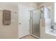 Clean bathroom with a walk-in shower and white door leading to a closet at 27328 Pine Straw Rd, Leesburg, FL 34748
