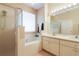 Bright bathroom featuring double vanity, soaking tub, and glass enclosed shower at 27328 Pine Straw Rd, Leesburg, FL 34748