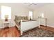 Cozy bedroom with hardwood floors, white furniture, and neutral decor at 27328 Pine Straw Rd, Leesburg, FL 34748