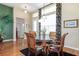 Dining room with hardwood floors, natural light, and a modern glass-top table at 27328 Pine Straw Rd, Leesburg, FL 34748