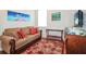 Living room with sofa, TV, and a decorative rug at 27328 Pine Straw Rd, Leesburg, FL 34748