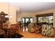Open-concept living room boasts natural light, hardwood floors, and tropical-themed decor at 27328 Pine Straw Rd, Leesburg, FL 34748