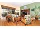 Cozy living room features a large window, stylish furniture, and a decorative entertainment center at 27328 Pine Straw Rd, Leesburg, FL 34748