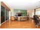 Spacious living room with hardwood floors, large windows, and an open-concept design at 27328 Pine Straw Rd, Leesburg, FL 34748