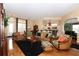 Bright living room with large windows, hardwood floors, and comfortable seating at 27328 Pine Straw Rd, Leesburg, FL 34748