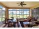 Well-lit sunroom with large windows offering views of the lawn at 27328 Pine Straw Rd, Leesburg, FL 34748