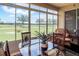 Bright sunroom with a dining set, seating area, and views of the green lawn at 27328 Pine Straw Rd, Leesburg, FL 34748