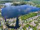 Aerial view of a lake community with waterfront homes and lush landscaping at 2815 Spyglass Cv, Longwood, FL 32779