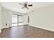 Bright bedroom featuring hardwood floors, sliding glass doors, and ample natural light at 2815 Spyglass Cv, Longwood, FL 32779