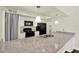 Kitchen with granite countertops, white cabinets, and black appliances at 2815 Spyglass Cv, Longwood, FL 32779