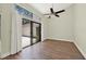 Bright room with hardwood floors, large glass doors, and modern ceiling fan at 2815 Spyglass Cv, Longwood, FL 32779