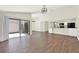 Open layout featuring dark wood floors, sliding glass doors to a patio, and a view to the kitchen at 2815 Spyglass Cv, Longwood, FL 32779