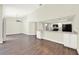 Open-concept living area with vaulted ceilings and wood-look floors, adjoining a modern kitchen at 2815 Spyglass Cv, Longwood, FL 32779