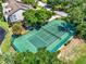 Aerial view of a green community tennis court with lush green landscaping at 2815 Spyglass Cv, Longwood, FL 32779