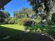 Expansive backyard featuring mature trees, charming outbuildings and plenty of space for outdoor activities at 32511 Purdum Ave, Leesburg, FL 34788